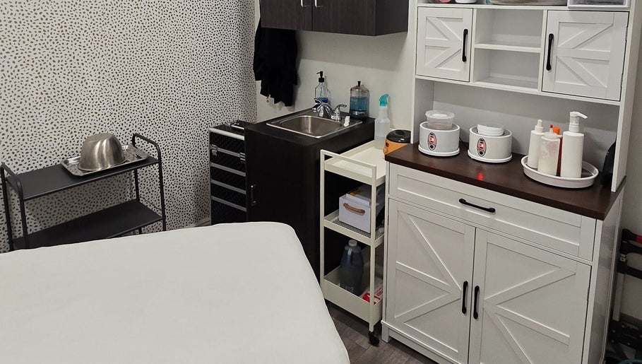 Cozy treatment room at Sugar Chic Studios in Idaho Falls, Idaho, US, featuring stylish storage and a sink.