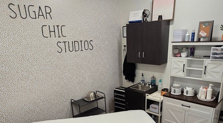 Interior of Sugar Chic Studios in Idaho Falls, Idaho, US featuring treatment area with modern decor.