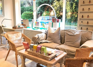 Inviting interior of The Bothy salon in York, England, GB, featuring cozy seating and nail polish display.