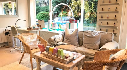 Inviting interior of The Bothy salon in York, England, GB, featuring cozy seating and nail polish display.