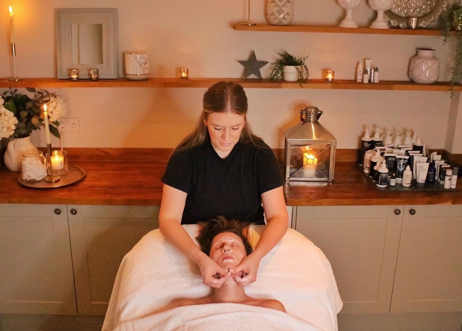 Relaxing facial massage at The Bothy, York, England, GB, in a serene, candle-lit room.