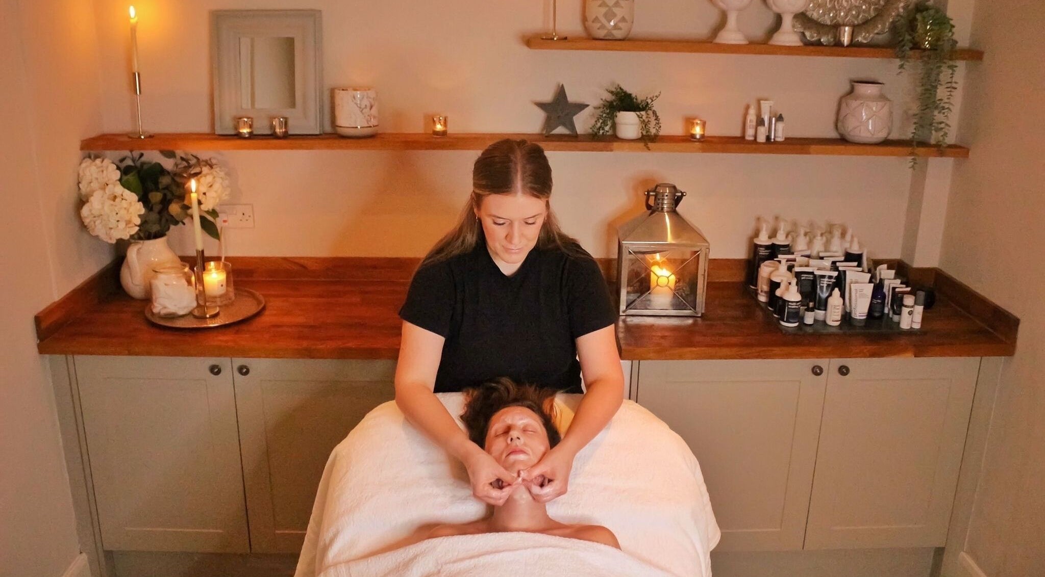 Relaxing facial massage at The Bothy, York, England, GB, in a serene, candle-lit room.