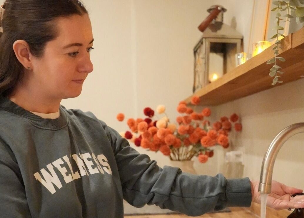 Guest enjoying tranquil moment at The Bothy, York, England, GB, with calming floral decor.