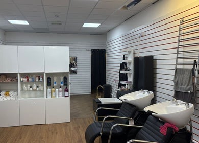 Modern salon interior of Fifi hair &beauty in Ashton-under-lyne, England featuring stylish washing stations.