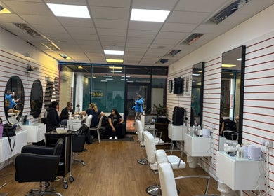 Modern interior of Fifi hair & beauty salon in Ashton-under-lyne, England, GB with stylish seating and mirrors.