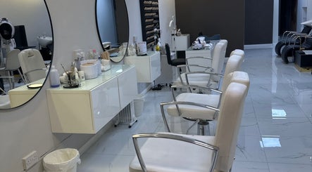 Modern interior of Fifi hair & beauty in Ashton-under-lyne, England, GB with stylish mirrors and salon chairs.