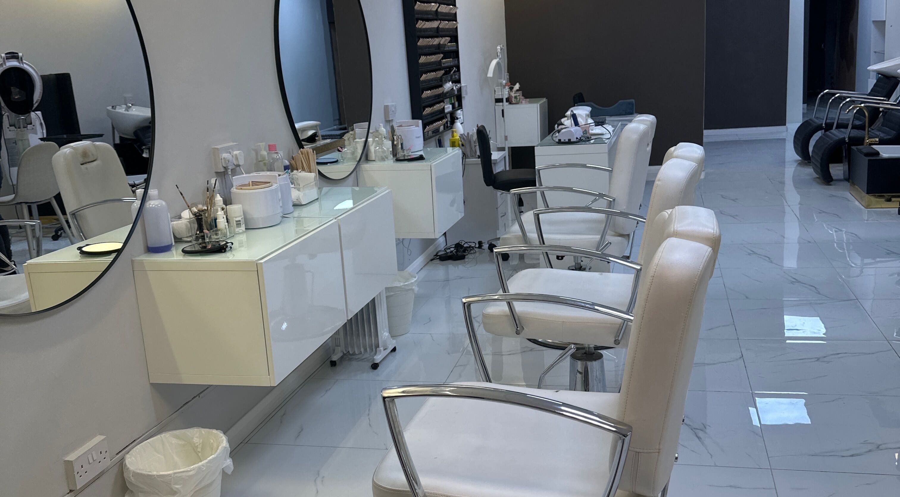 Modern interior of Fifi hair & beauty in Ashton-under-lyne, England, GB with stylish mirrors and salon chairs.