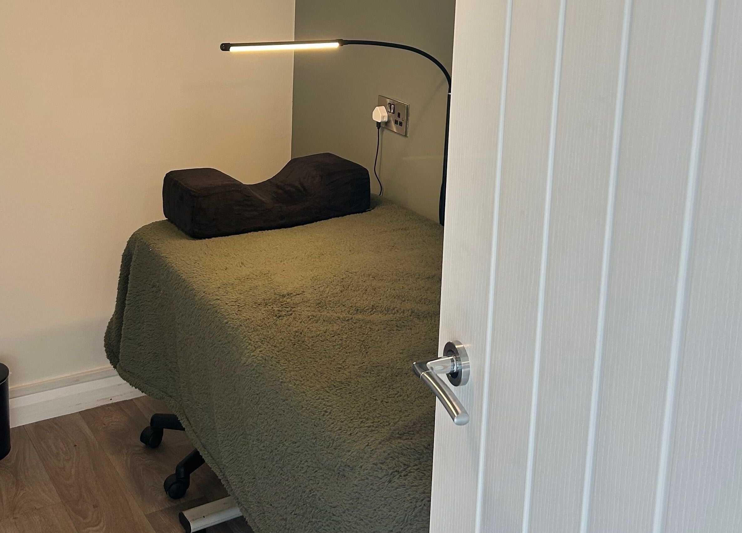 Relaxing therapy room at Prettyme Beauty Allestree, Derby, England, GB, with plush bedding and modern lighting.