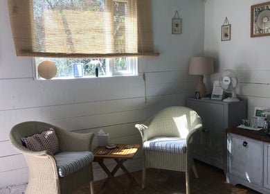 Cozy relaxation corner at In8 Wellbeing, Milton Ernest, England, GB with wicker chairs and natural decor.
