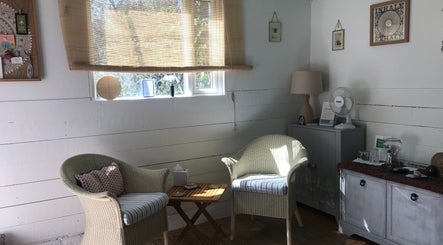 Cozy relaxation corner at In8 Wellbeing, Milton Ernest, England, GB with wicker chairs and natural decor.