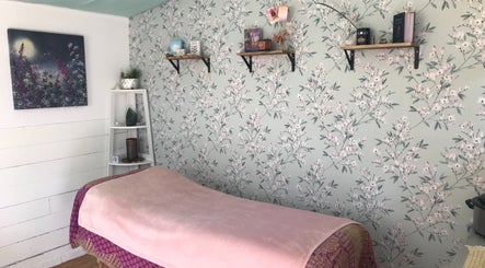 Calming therapy room at In8 Wellbeing, Milton Ernest, England, GB, with floral wallpaper and soft lighting.