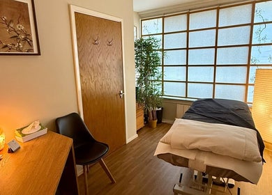 Relaxing massage room at Lucia Massage Therapy in Camden, England, GB with warm lighting and a massage table.