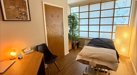 Relaxing massage room at Lucia Massage Therapy in Camden, England, GB with warm lighting and a massage table.