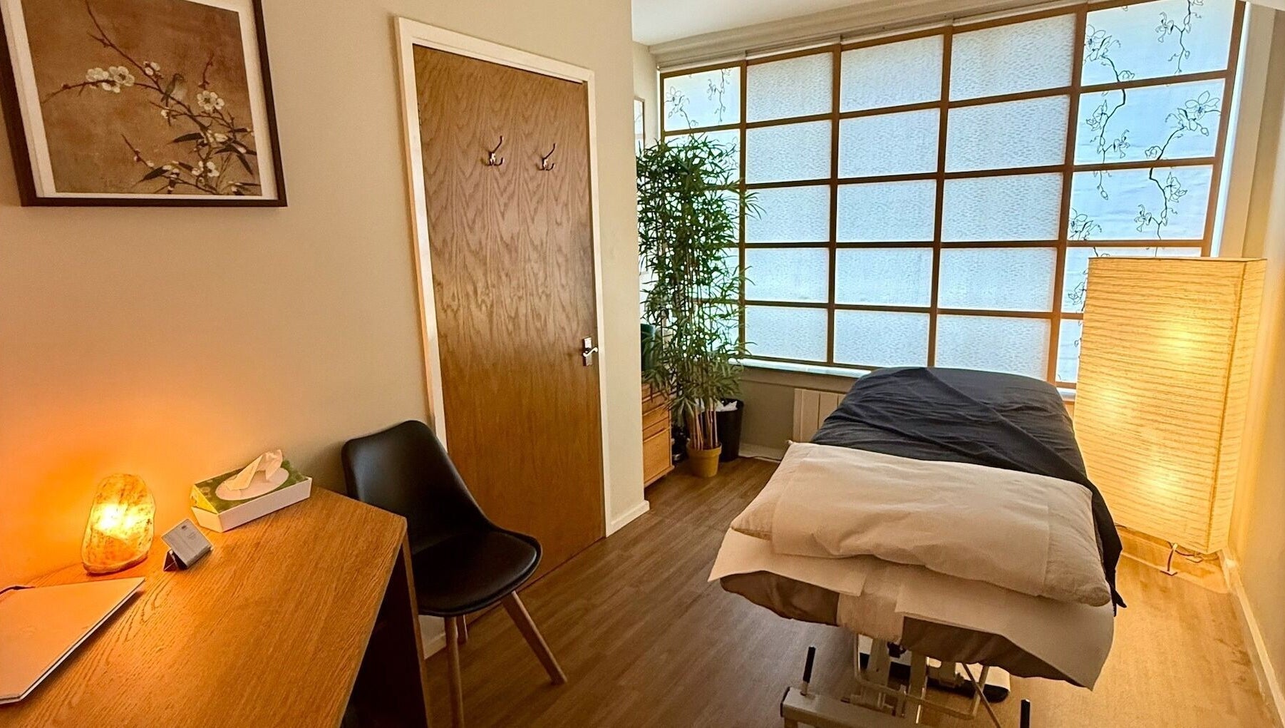 Lucia Massage Therapy's serene treatment room in Camden, England, GB, featuring a cozy massage table and warm decor.