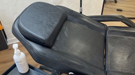 Comfortable black treatment chair at Medi Dermis Aesthetics, Chorley, England, GB, ready for clients.