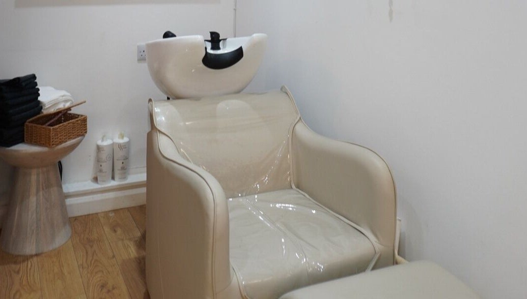 Modern hair washing station at Elle Collective, St Helier, Channel Islands, JE, featuring elegant seating.