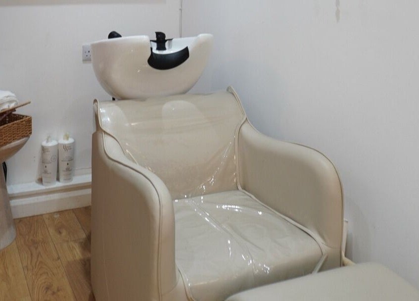 Modern hair washing station at Elle Collective, St Helier, Channel Islands, JE, featuring elegant seating.