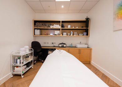 Francisca Wellbeing Studio treatment room in London, England, GB with massage table and wellness essentials.
