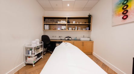 Francisca Wellbeing Studio treatment room in London, England, GB with massage table and wellness essentials.