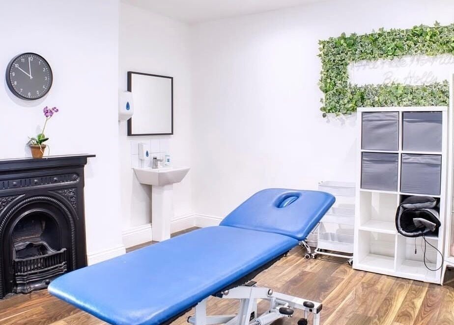 Peaceful treatment room at Face and Body Therapies by Christina, London, England, GB with blue massage table.