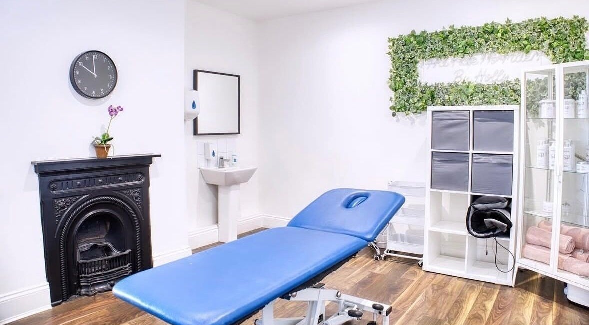Peaceful treatment room at Face and Body Therapies by Christina, London, England, GB with blue massage table.