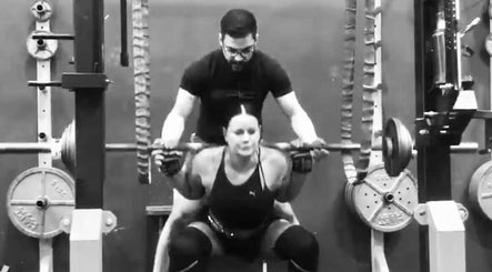 Personal trainer assisting client with squats at Leaha Toowoomba in Toowoomba City, Queensland, AU.