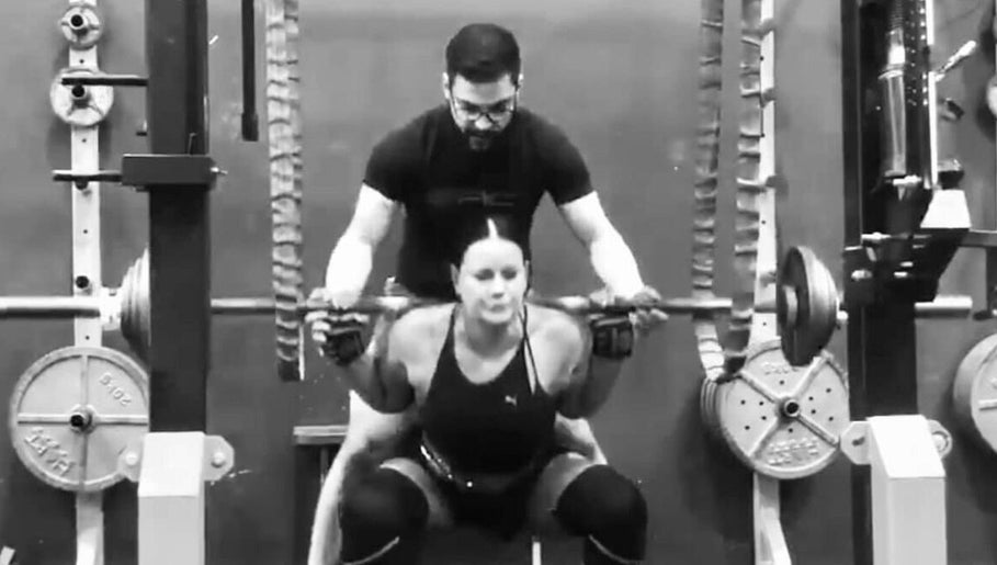 Trainer assists woman during weightlifting at Leaha Toowoomba, Toowoomba City, Queensland, AU.