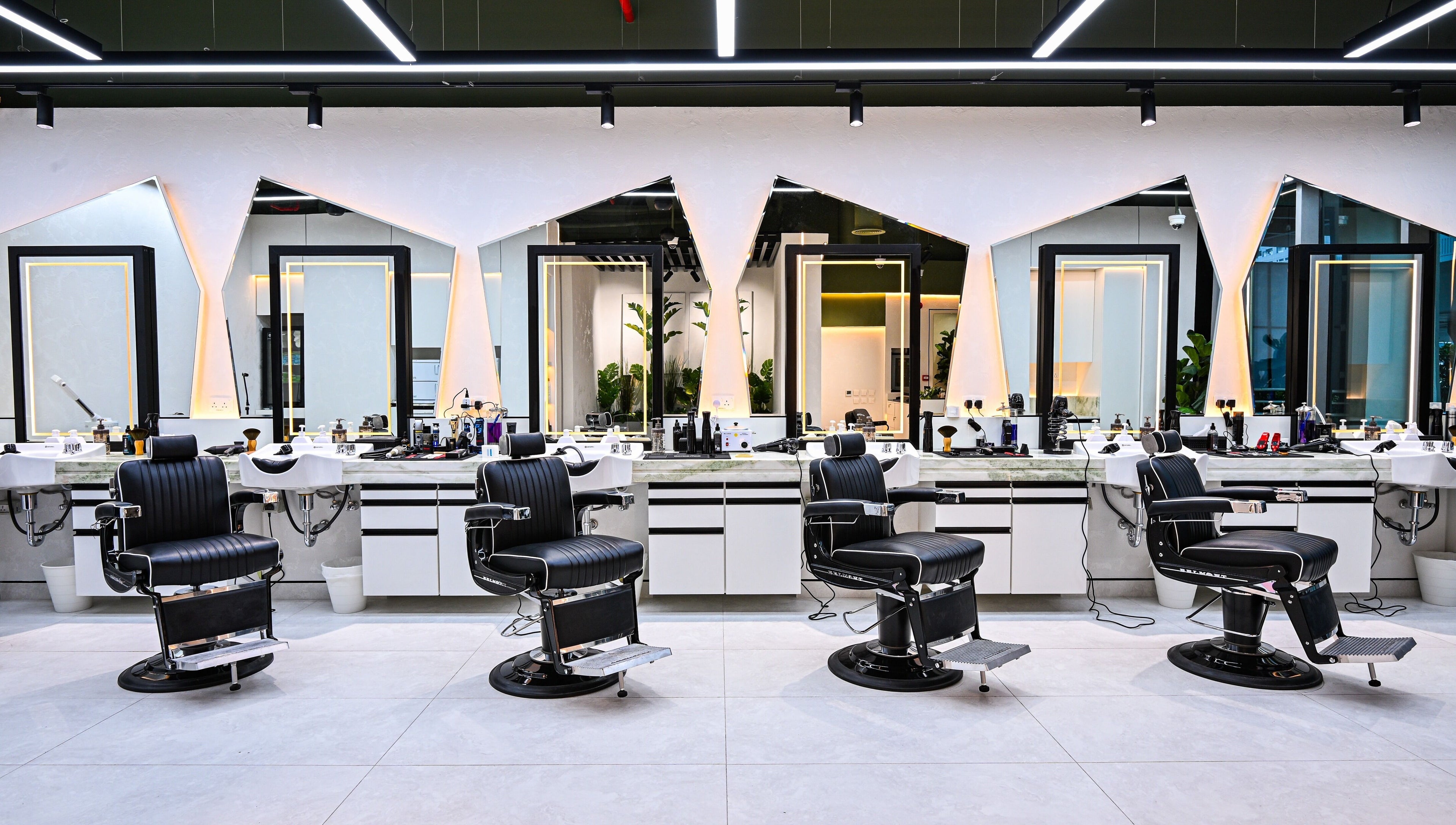 Elegant barber chairs in Mantis Gent’s Salon - Business Bay, Dubai, Dubai, AE with modern mirrors and lighting.