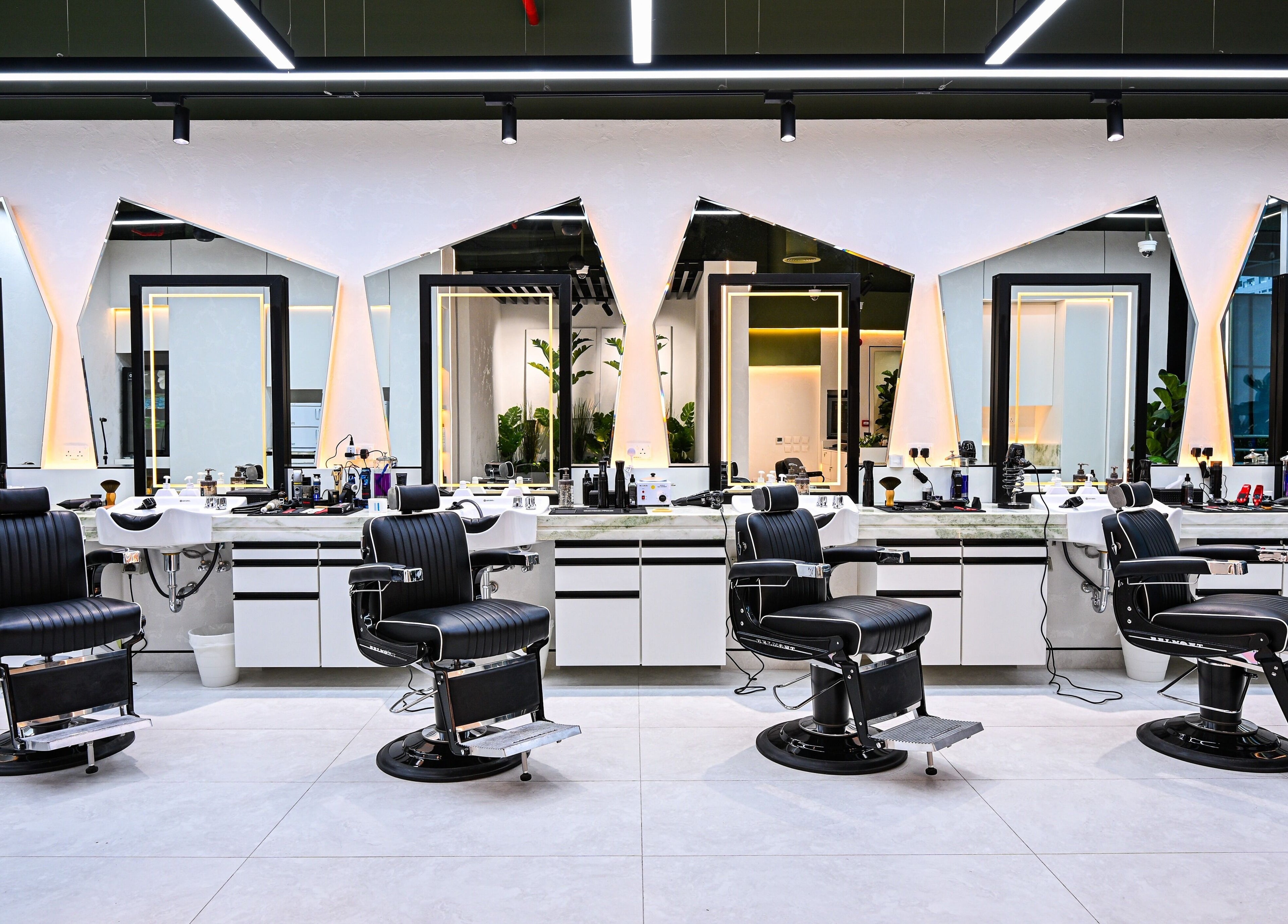 Elegant barber chairs in Mantis Gent’s Salon - Business Bay, Dubai, Dubai, AE with modern mirrors and lighting.
