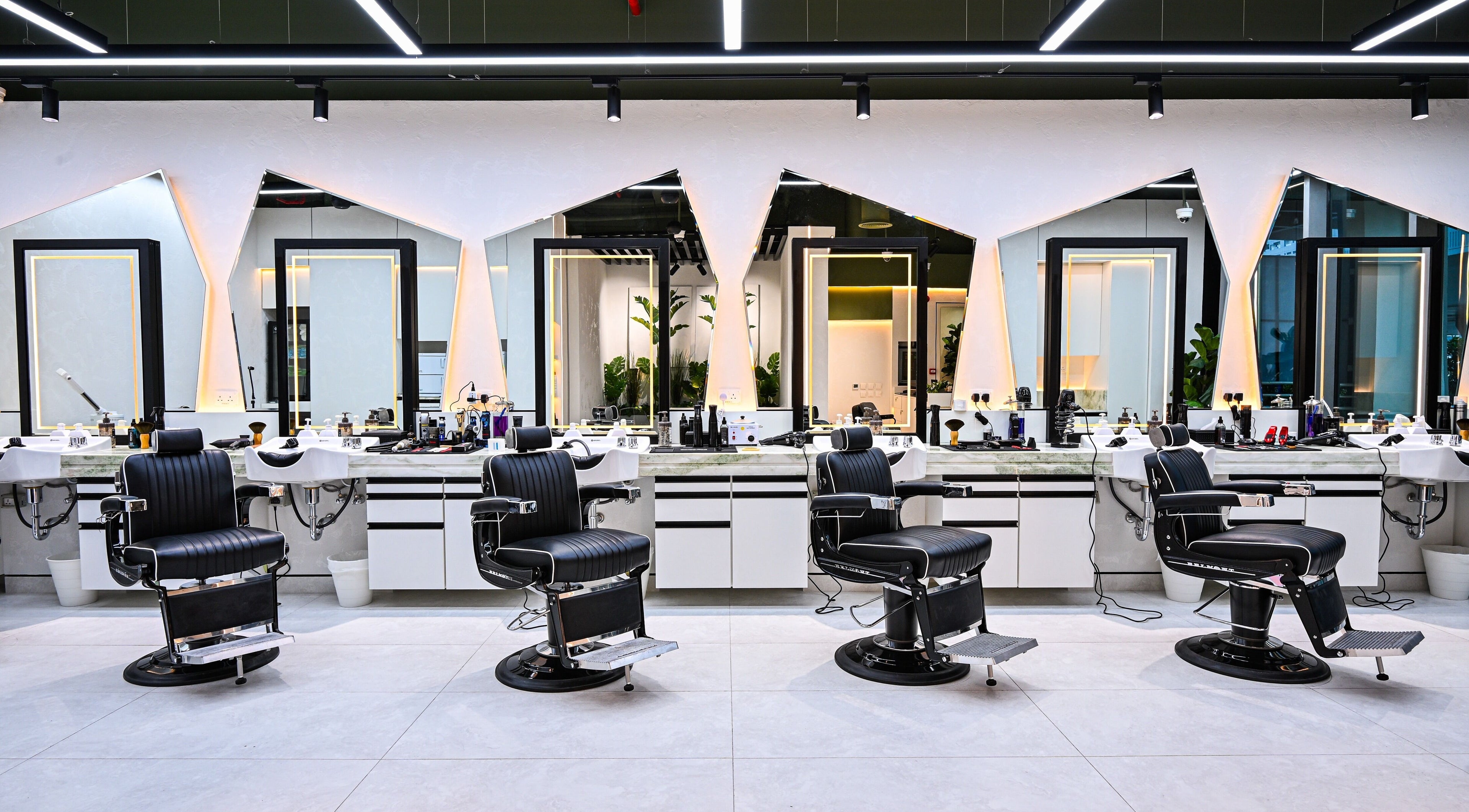Elegant barber chairs in Mantis Gent’s Salon - Business Bay, Dubai, Dubai, AE with modern mirrors and lighting.