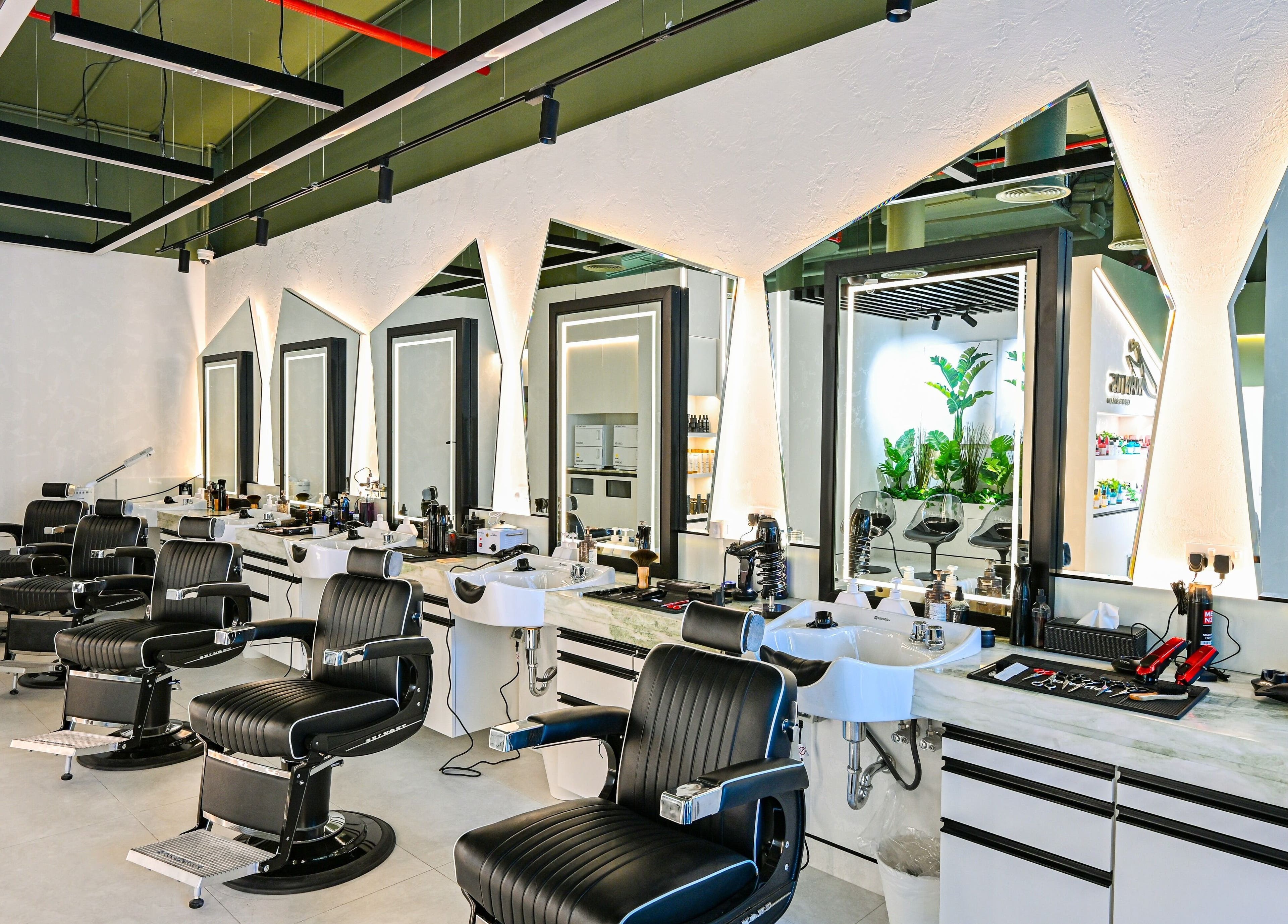 Modern barber chairs at Mantis Gent’s Salon - Business Bay, Dubai, Dubai, AE, with sleek salon setup.