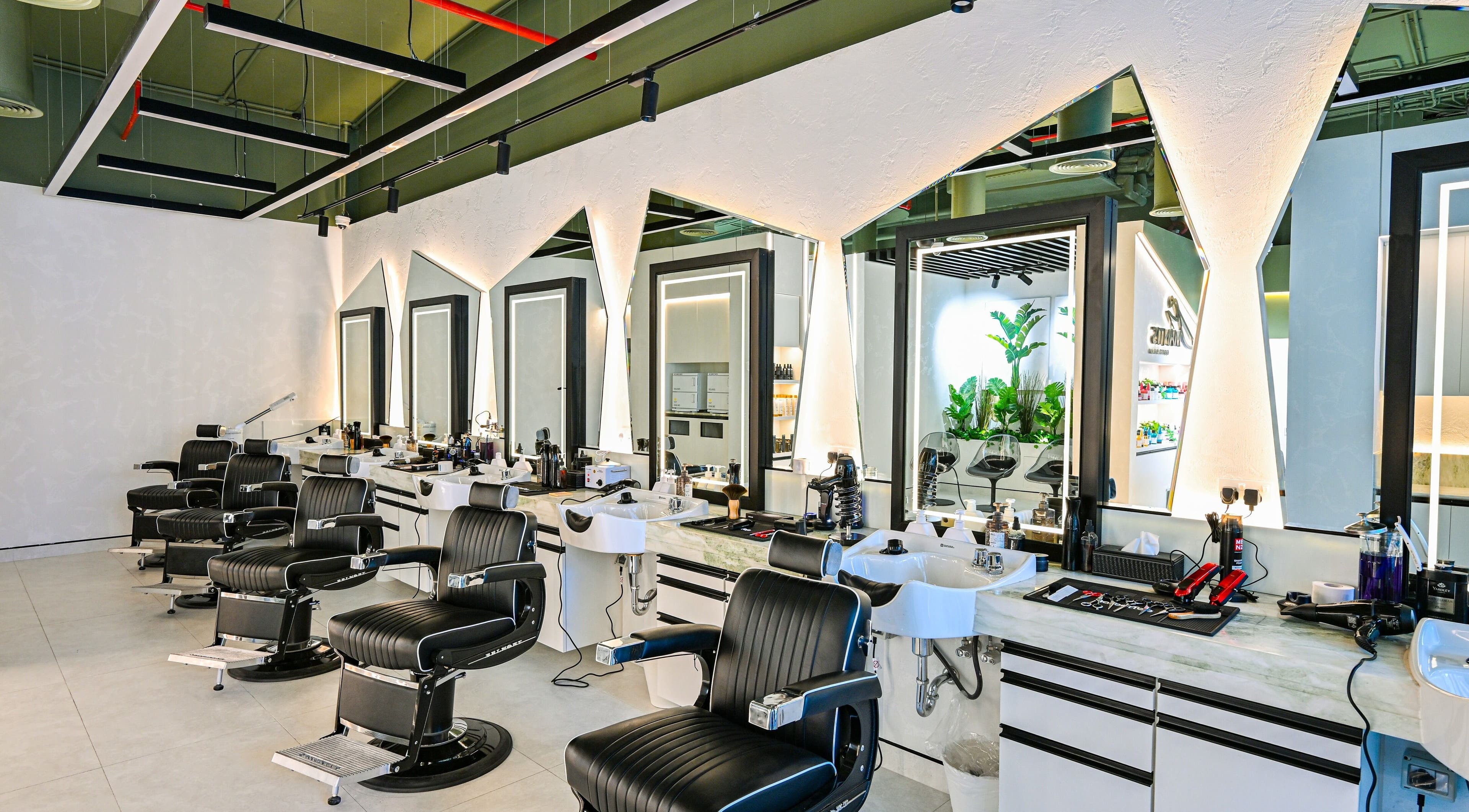 Modern barber chairs at Mantis Gent’s Salon - Business Bay, Dubai, Dubai, AE, with sleek salon setup.