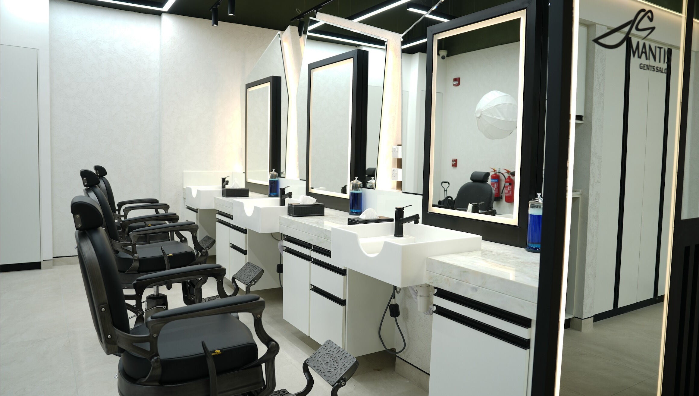 Chic barber chairs and modern mirrors at Mantis Gent’s Salon - Yas Island, Abu Dhabi, AE.
