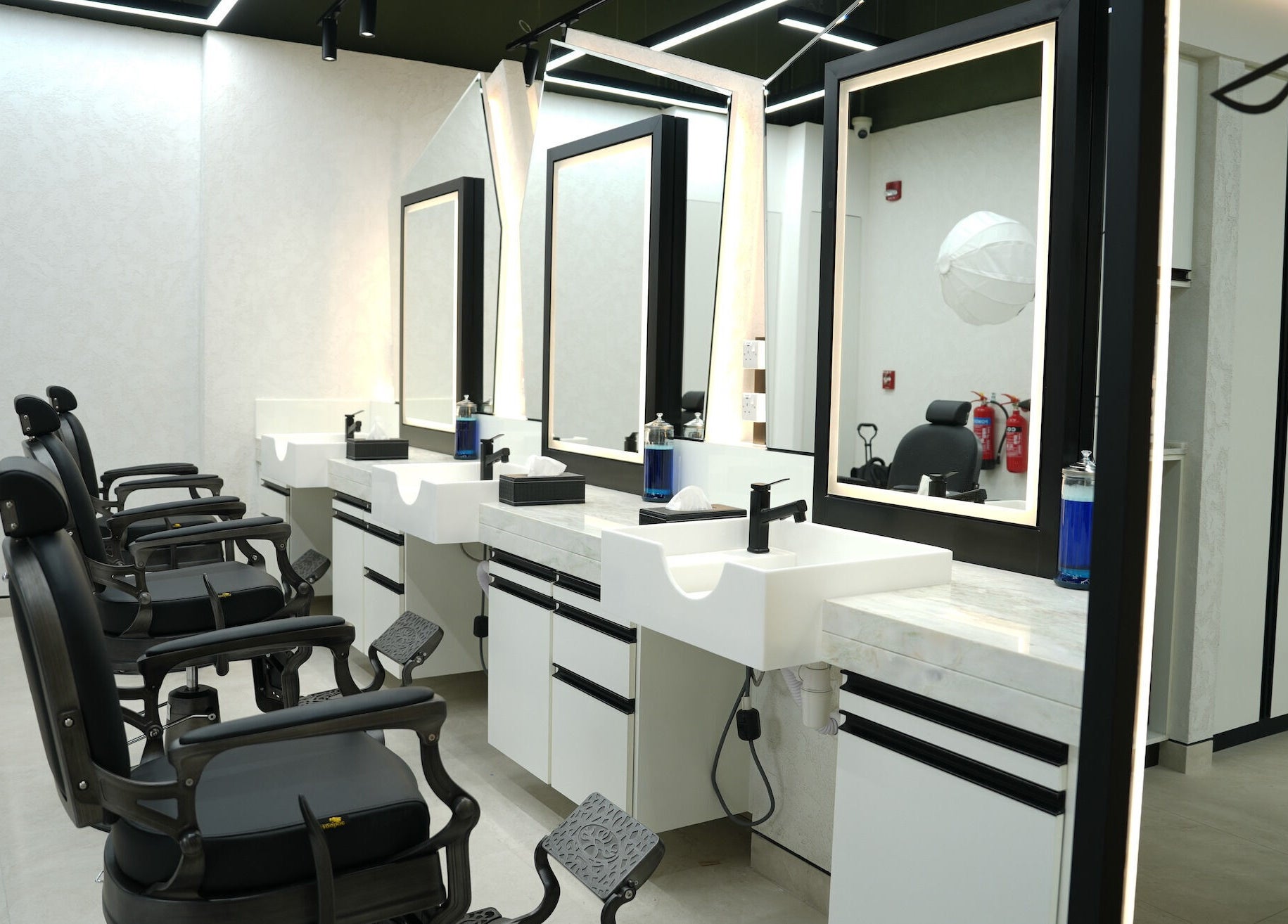 Chic barber chairs and modern mirrors at Mantis Gent’s Salon - Yas Island, Abu Dhabi, AE.