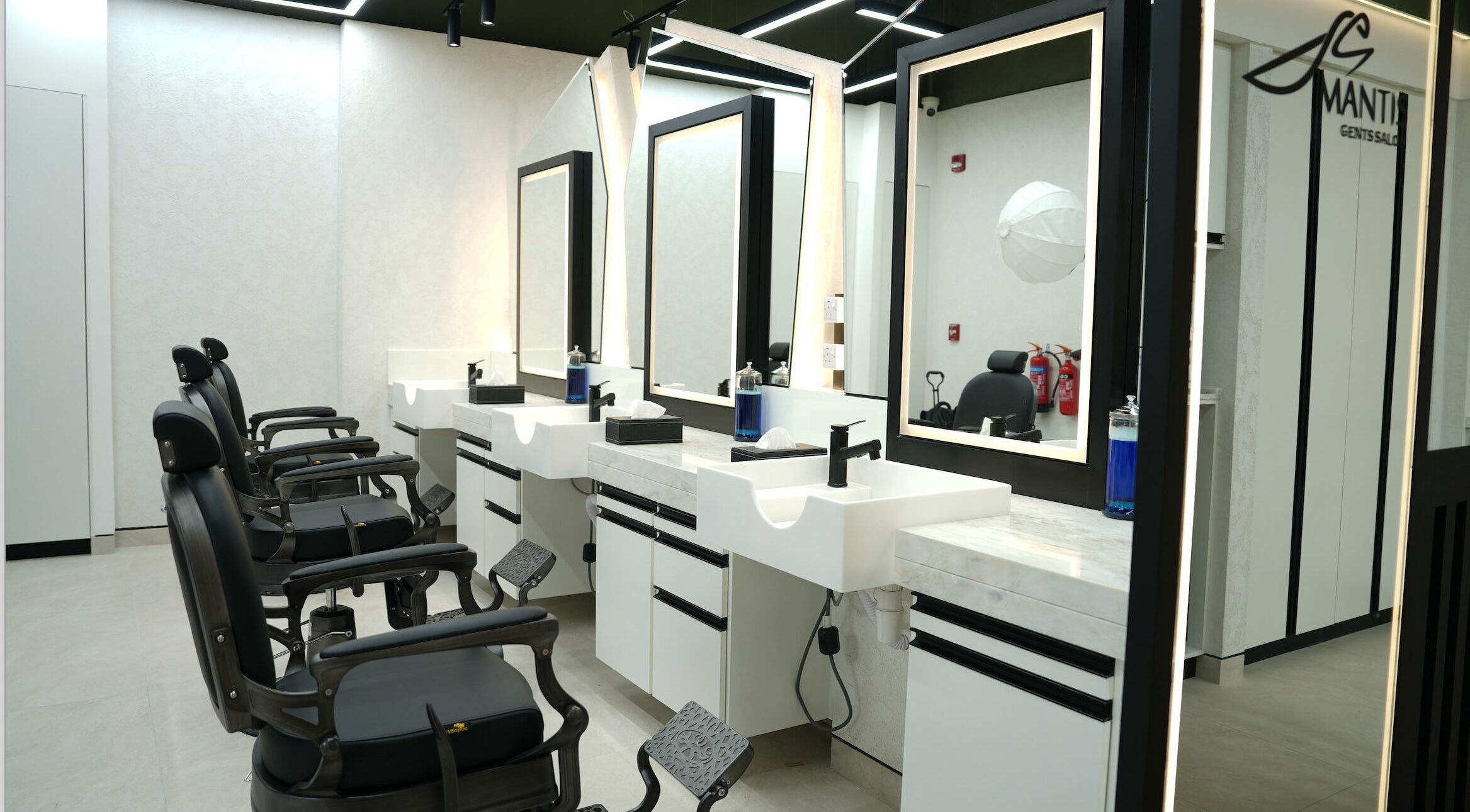 Chic barber chairs and modern mirrors at Mantis Gent’s Salon - Yas Island, Abu Dhabi, AE.