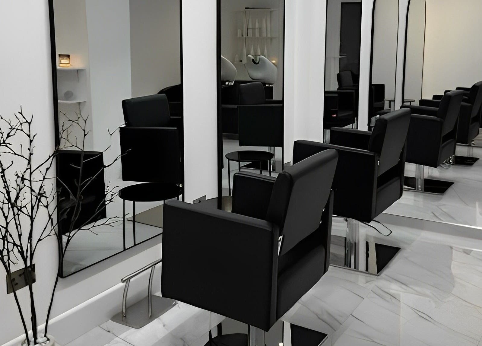Elegant salon setup at STUDIO HONEY, Southampton, England, GB featuring sleek black chairs and large mirrors.