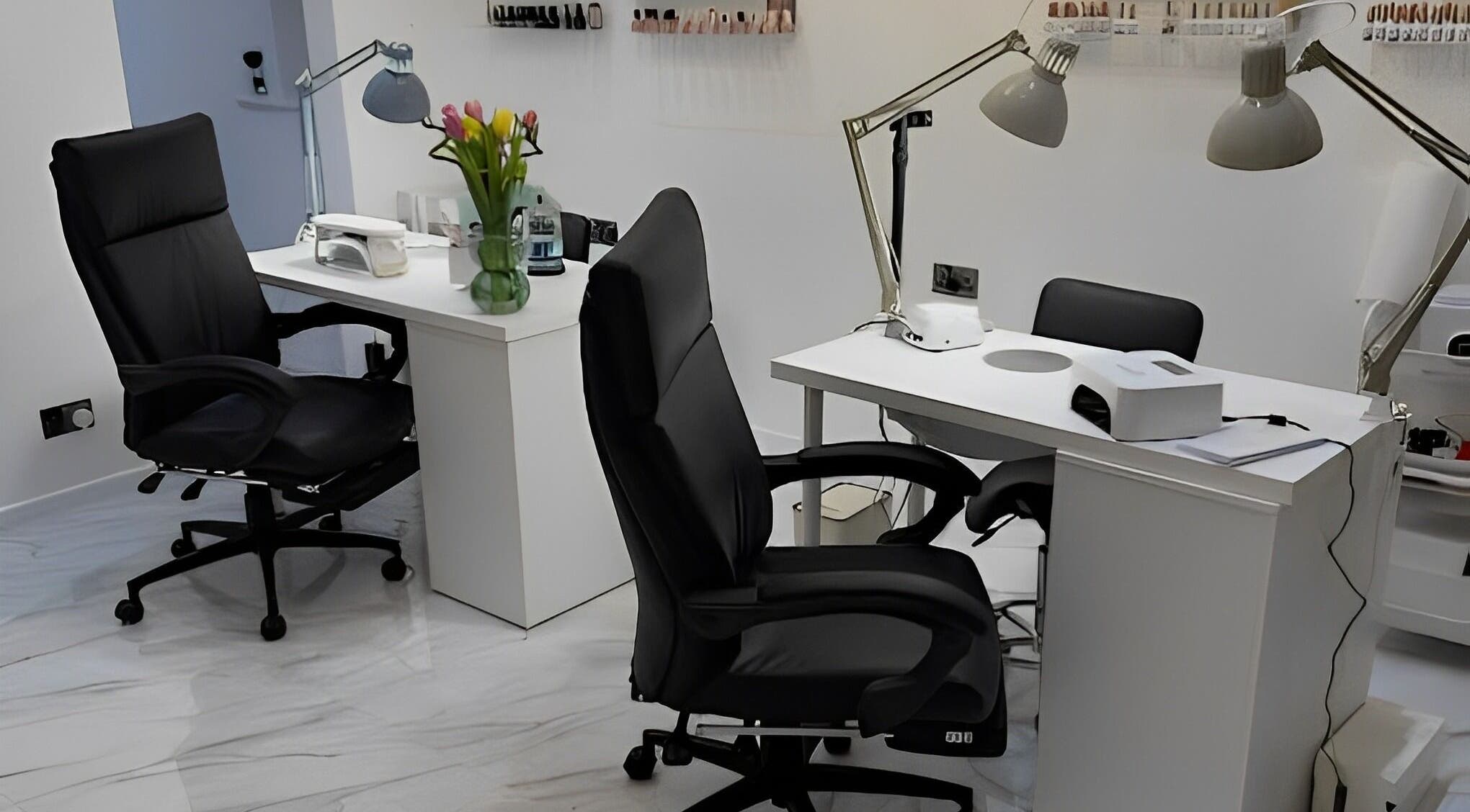 Chic manicure stations at STUDIO HONEY, Southampton, England, GB, featuring sleek black chairs and modern lighting.