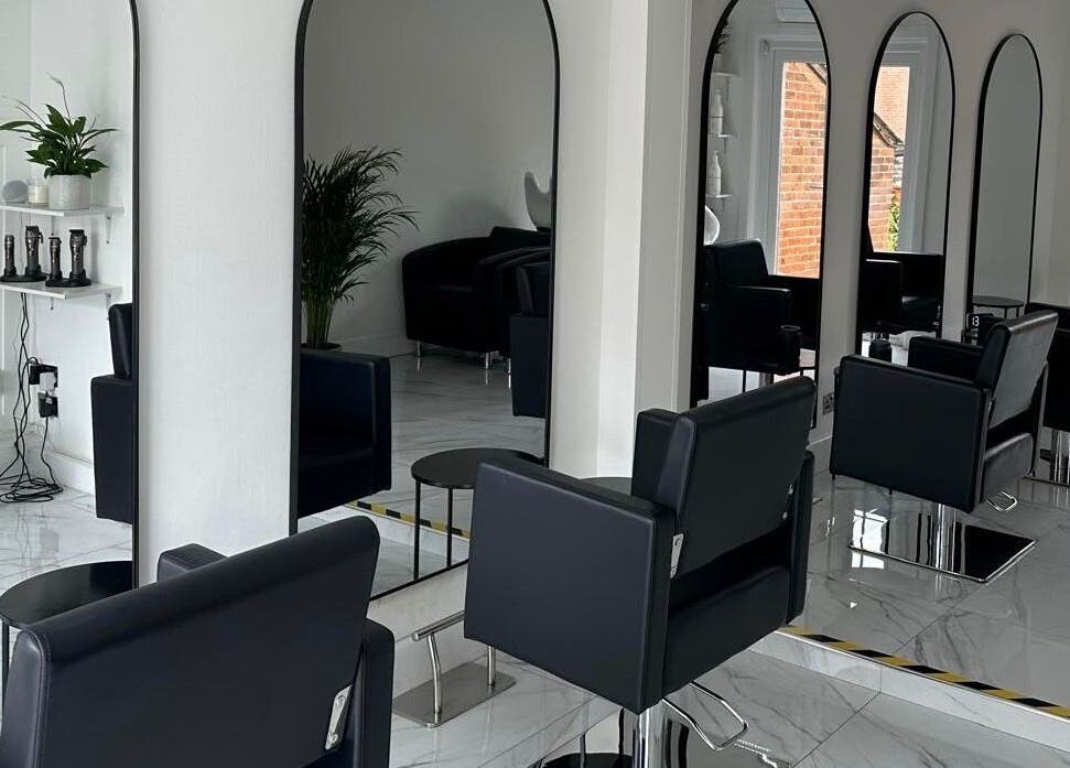 Stylish interior of STUDIO HONEY in Southampton, England, GB featuring elegant salon chairs and mirrors.