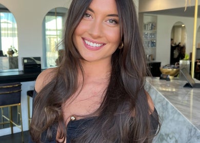 Smiling woman with long hair at STUDIO QUE, Innaloo, Western Australia, AU.