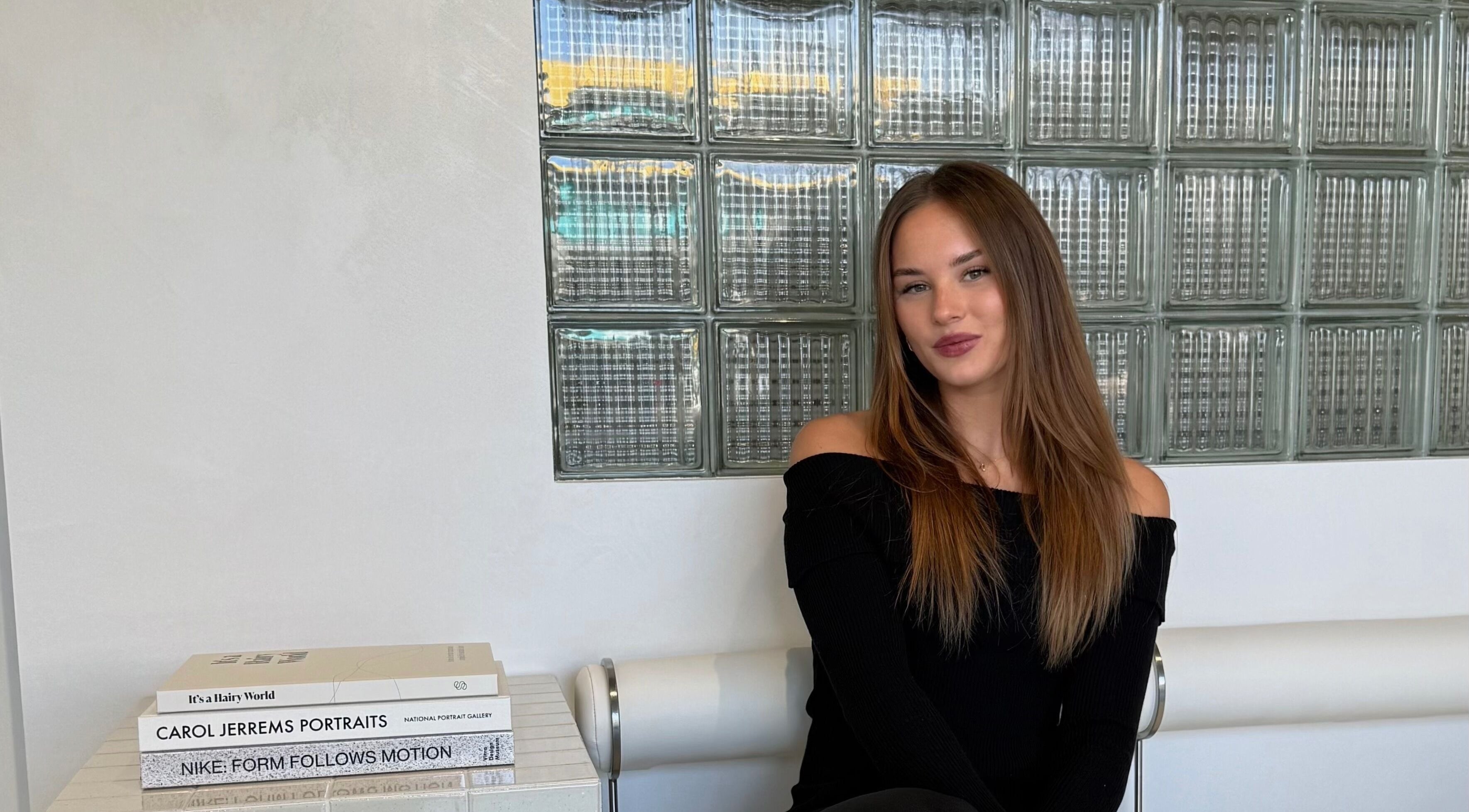 Sophisticated woman seated at STUDIO QUE, Innaloo, Western Australia, AU, showcasing modern style.