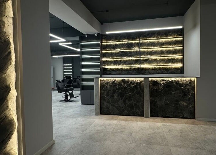 Sleek interior of Barber&Co in Chișinău, showcasing stylish seating and ambient lighting.