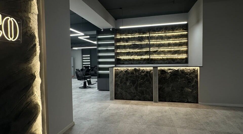 Sleek interior of Barber&Co in Chișinău, showcasing stylish seating and ambient lighting.