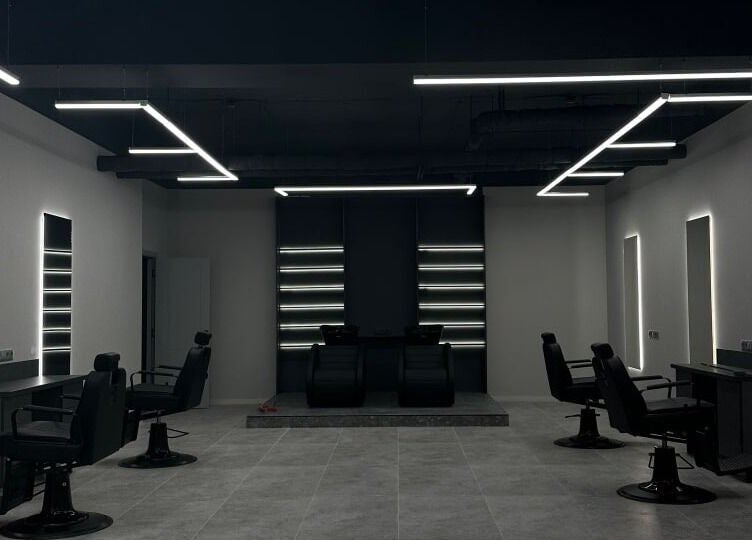 Sleek interior of Barber&Co in Chișinău, Chișinău, MD with modern barber chairs and stylish lighting.