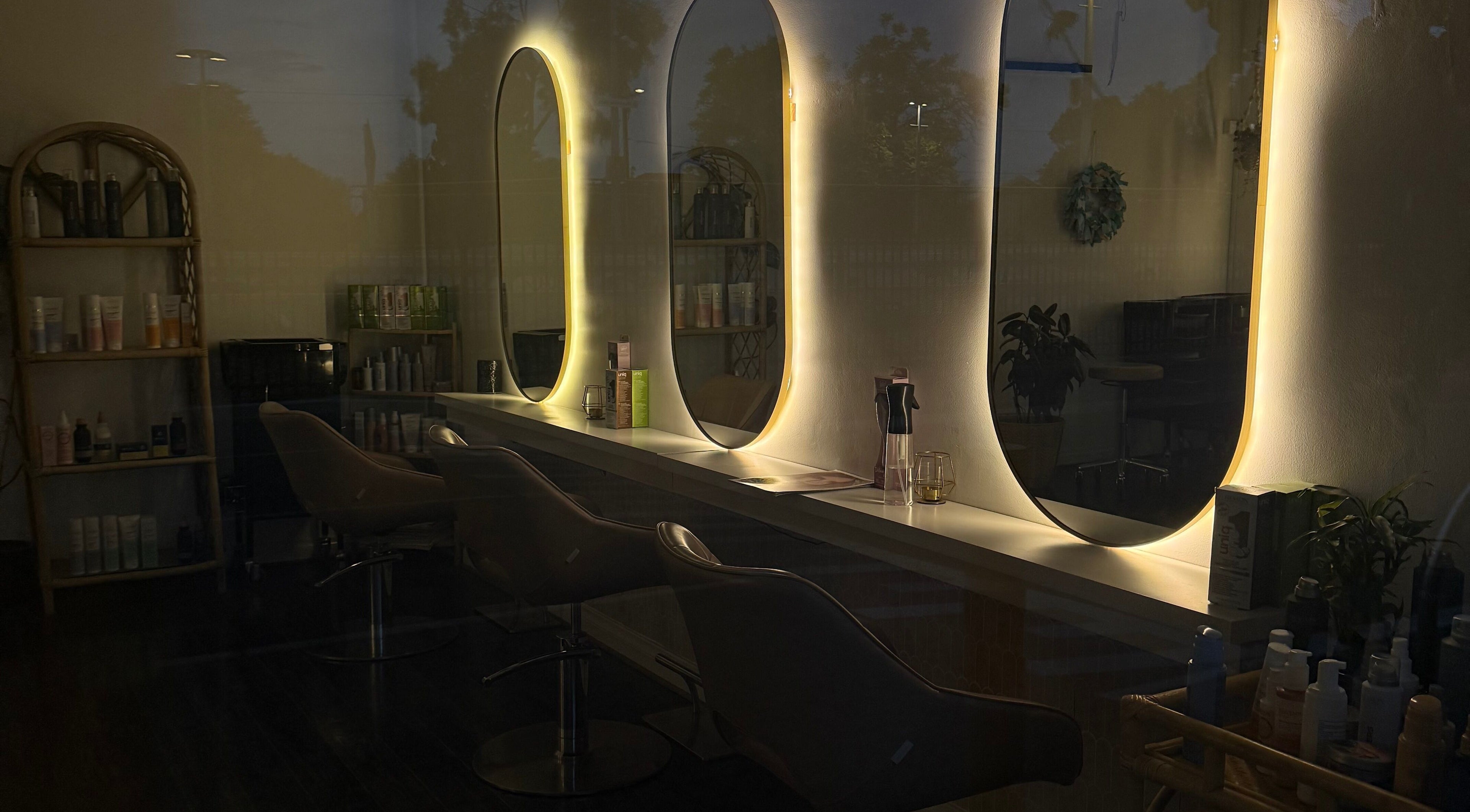 Chic salon interior at Hair by Alice, Woodville Park, South Australia, AU, featuring stylish mirrors and chairs.