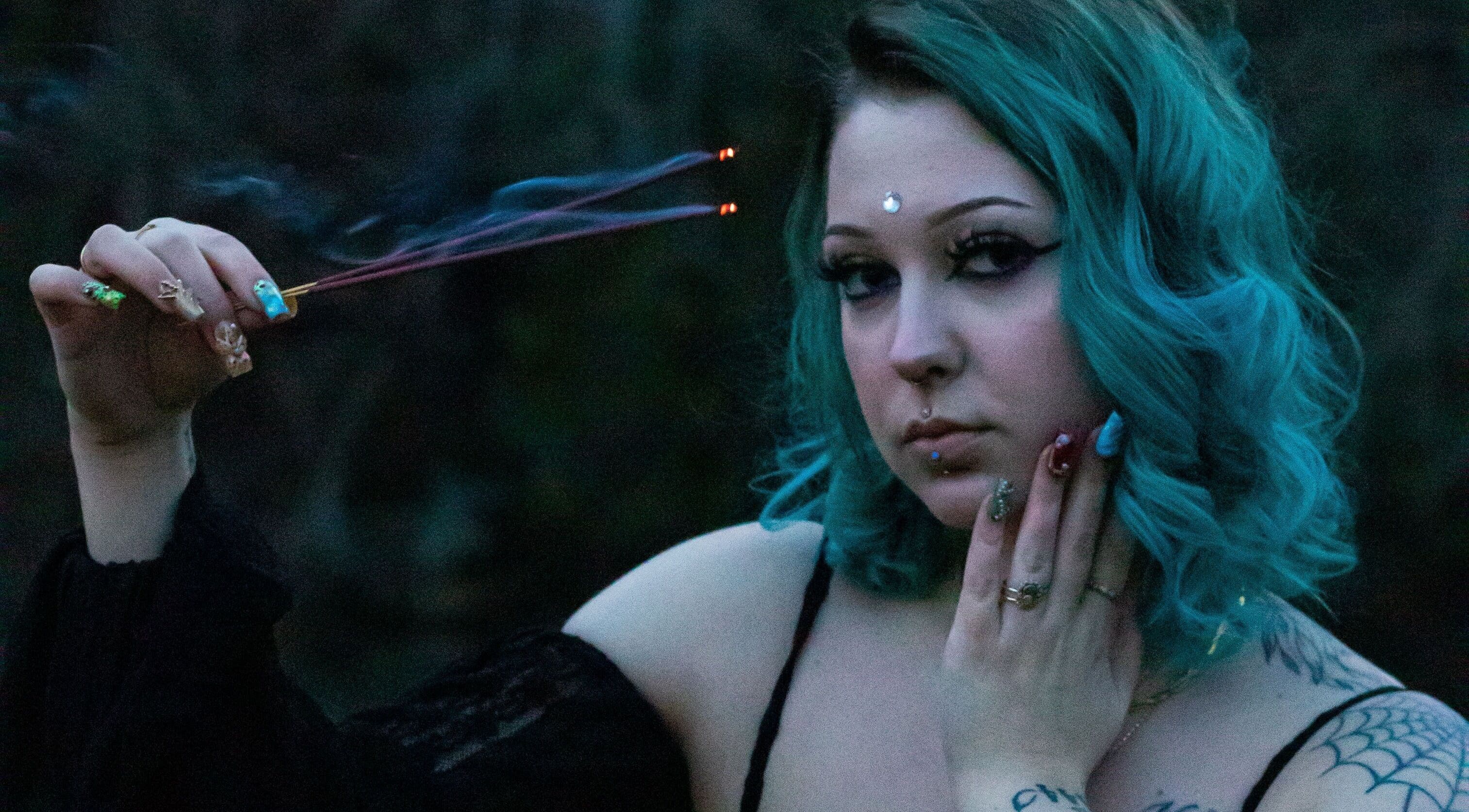 Woman with blue hair and incense at Her Magickal Touch, Bridgewater, Virginia, US.