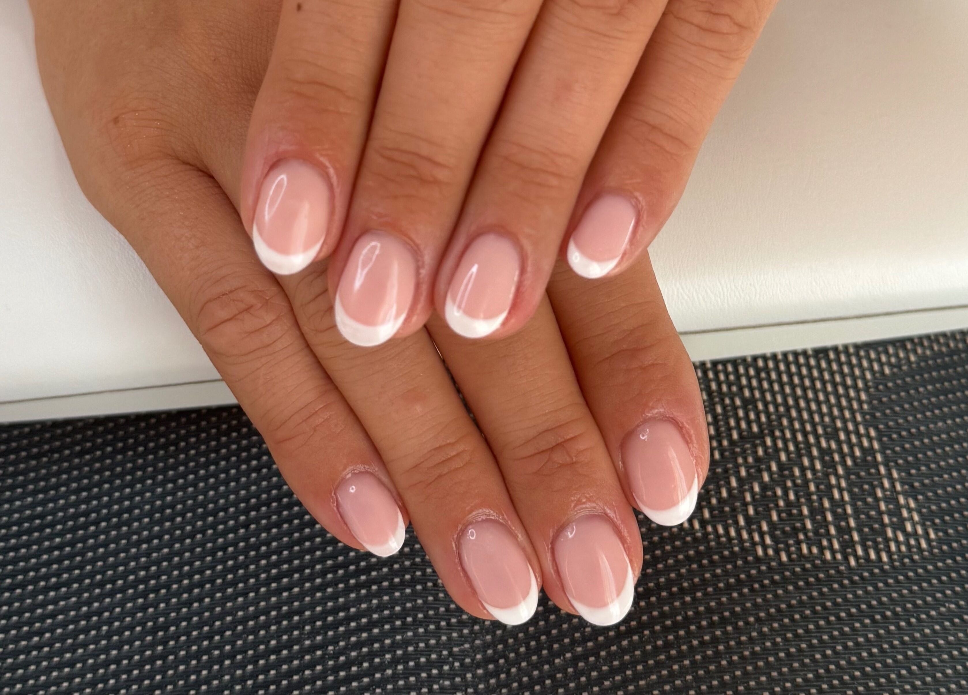 Perfect French manicure at BlushBeauty, Poole, England, GB showcasing elegant nail art.