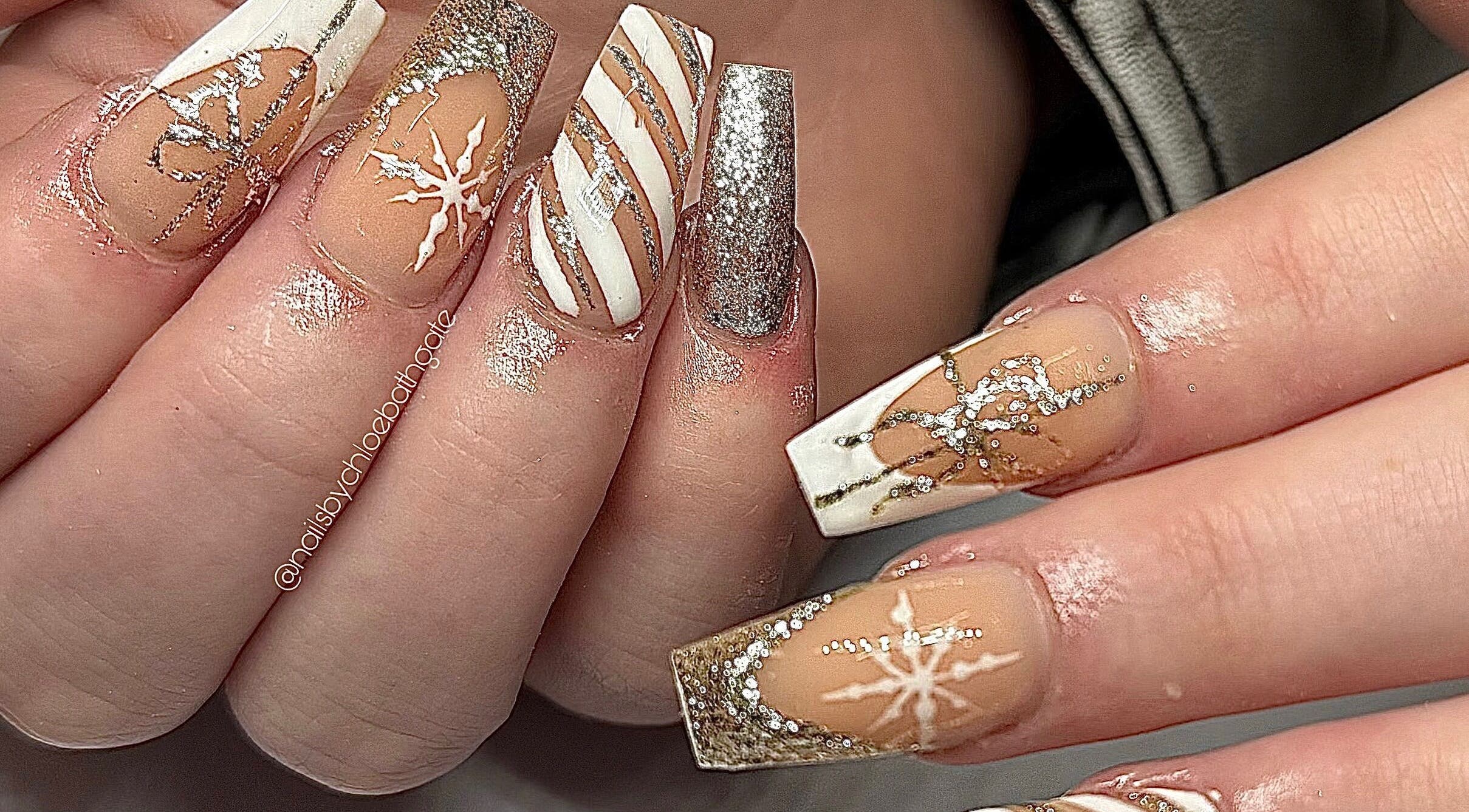 Intricate winter-themed nail art with glitter at Nailsbychloebathgate, Doncaster, England, GB.