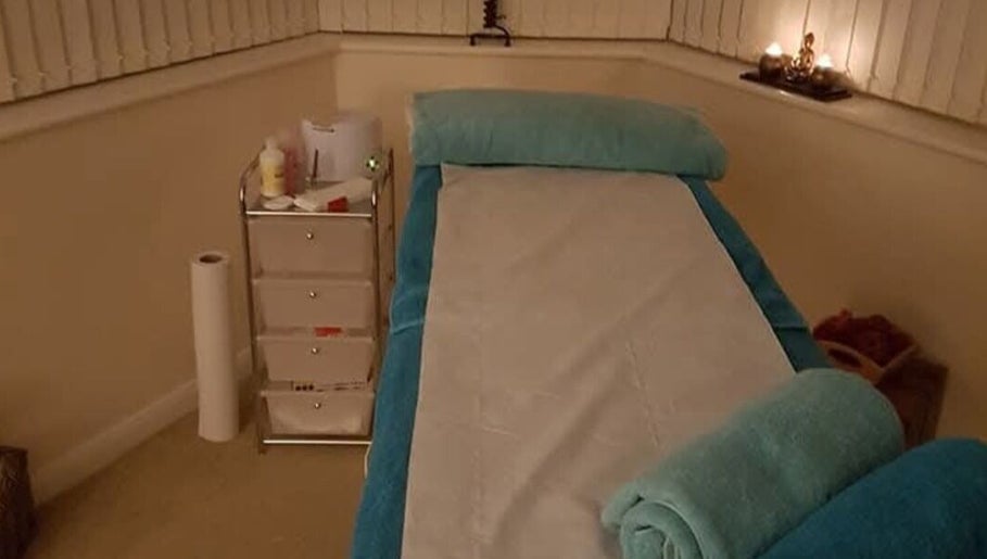Tranquil treatment room at Radiant Wellness in King's Lynn, England, GB with a massage table and ambient lighting.