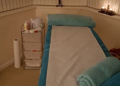 Tranquil treatment room at Radiant Wellness in King's Lynn, England, GB with a massage table and ambient lighting.
