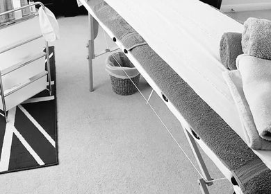 Massage table and towels at Radiant Wellness in King's Lynn, England, GB for relaxing treatment.